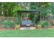 Charming backyard swing with decorative accents and a peaceful setting at 366 Coopers Pond Dr, Lawrenceville, GA 30044