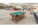 Basement rec room with billiards table, neutral carpet, and decorative sports memorabilia displayed on the walls at 366 Coopers Pond Dr, Lawrenceville, GA 30044