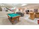 Spacious basement rec room with a pool table, bar area, and ample space for recreation and entertainment at 366 Coopers Pond Dr, Lawrenceville, GA 30044