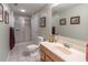 Bathroom featuring a sink with traditional cabinetry, a walk-in shower, and neutral tones at 366 Coopers Pond Dr, Lawrenceville, GA 30044