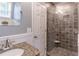 Bathroom featuring a tiled shower with a built-in seat, granite counter, and neutral wall color at 366 Coopers Pond Dr, Lawrenceville, GA 30044