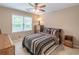 Cozy bedroom with a ceiling fan and a large window at 366 Coopers Pond Dr, Lawrenceville, GA 30044