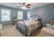 Inviting bedroom with soft blue walls and natural light at 366 Coopers Pond Dr, Lawrenceville, GA 30044