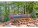 Welcoming entrance to Cooper's Pond with beautiful landscaping and mature trees at 366 Coopers Pond Dr, Lawrenceville, GA 30044