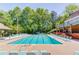 Community pool area with lounge chairs and covered pavilion for relaxing poolside at 366 Coopers Pond Dr, Lawrenceville, GA 30044