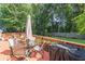 Outdoor deck area perfect for al fresco dining with seating and a grill at 366 Coopers Pond Dr, Lawrenceville, GA 30044