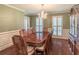 Elegant dining room with a wood table, chandelier, and plenty of natural light, perfect for Gathering gatherings at 366 Coopers Pond Dr, Lawrenceville, GA 30044