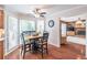 Cozy kitchen eating area with window views and seamless access to a Gathering room with a fireplace at 366 Coopers Pond Dr, Lawrenceville, GA 30044