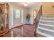 Inviting foyer with hardwood floors, staircase, and elegant decor at 366 Coopers Pond Dr, Lawrenceville, GA 30044