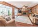 Warm and inviting Gathering room with wood paneling, built-in shelves, and a brick fireplace, perfect for relaxation at 366 Coopers Pond Dr, Lawrenceville, GA 30044