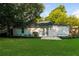 View of backyard with green grass and the rear of the home at 3993 Forrest Ct, Atlanta, GA 30341