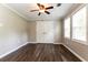 Bright bedroom with wood-look floors, white trim, and a ceiling fan with light at 3993 Forrest Ct, Atlanta, GA 30341