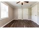 Bedroom featuring wood-look floors, white trim, and a ceiling fan with light at 3993 Forrest Ct, Atlanta, GA 30341