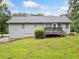 A view of the back of the house and backyard, which features a deck and a fence at 5045 Shadow Wood Dr, Canton, GA 30114
