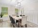 Bright dining area with large windows, decorative trim, and seating for six at 5045 Shadow Wood Dr, Canton, GA 30114