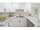 Modern kitchen with bright white cabinets, stainless appliances, and granite countertops at 5045 Shadow Wood Dr, Canton, GA 30114