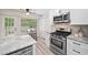 Modern kitchen with stainless steel appliances and an attached dining nook with deck access at 5045 Shadow Wood Dr, Canton, GA 30114