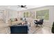 Bright living room featuring neutral walls, modern furnishings, and refinished hardwood floors at 5045 Shadow Wood Dr, Canton, GA 30114