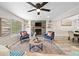 Spacious living room featuring modern decor, a ceiling fan, a fireplace and a window at 5045 Shadow Wood Dr, Canton, GA 30114