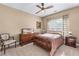 A warm bedroom is furnished with a traditional wooden bed set and completed with a ceiling fan at 994 Fairview Club Cir, Dacula, GA 30019