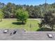This aerial view from the roof features a lush lawn, American flag, and a treed landscape at 1797 Chandler Rd, Lawrenceville, GA 30045