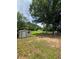 Expansive backyard featuring lush greenery, mature trees, and a storage shed, perfect for outdoor activities and storage at 1797 Chandler Rd, Lawrenceville, GA 30045