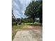 Generous backyard featuring mature trees, lush grass, a storage shed, and a concrete patio, ideal for outdoor living and storage at 1797 Chandler Rd, Lawrenceville, GA 30045