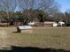 Large, sunny backyard featuring a storage shed and a small brick structure at 1797 Chandler Rd, Lawrenceville, GA 30045