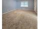 Spacious bedroom with neutral carpet and a window providing natural light, creating a comfortable and relaxing retreat at 1797 Chandler Rd, Lawrenceville, GA 30045
