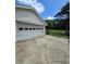 Spacious garage with multiple windows and a wide concrete driveway, providing ample parking and storage at 1797 Chandler Rd, Lawrenceville, GA 30045