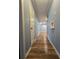 Hallway with wood floors and blue walls, offering access to various rooms and storage spaces at 1797 Chandler Rd, Lawrenceville, GA 30045