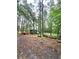 A forested lot with chipper, dump trailer, and lumber truck at 1797 Chandler Rd, Lawrenceville, GA 30045