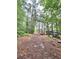 A forested lot with chipper, dump trailer, and lumber truck at 1797 Chandler Rd, Lawrenceville, GA 30045