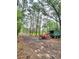 A forested lot with a chipper and dump trailer at 1797 Chandler Rd, Lawrenceville, GA 30045