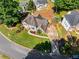 Aerial view of landscaped home with a lush lawn, mature trees, and a well-maintained driveway at 4913 Farm Valley Ne Dr, Woodstock, GA 30188