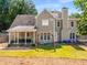 Spacious backyard featuring a covered patio, a swing set, and plenty of room for outdoor activities at 4913 Farm Valley Ne Dr, Woodstock, GA 30188