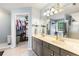 Bright bathroom featuring a double vanity, large mirror, and closet access at 4913 Farm Valley Ne Dr, Woodstock, GA 30188