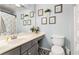 Well-lit bathroom featuring modern vanity, framed art, and patterned tile flooring at 4913 Farm Valley Ne Dr, Woodstock, GA 30188