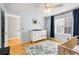Bright Bedroom featuring hardwood floors, modern decor, and a changing table at 4913 Farm Valley Ne Dr, Woodstock, GA 30188