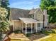 Exterior angle of the rear of the house highlighting a covered patio and a swing set in the yard at 4913 Farm Valley Ne Dr, Woodstock, GA 30188