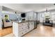 Spacious eat-in kitchen features a large island with granite counters and modern stainless steel appliances at 4913 Farm Valley Ne Dr, Woodstock, GA 30188
