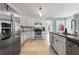 Eat-in kitchen features stainless steel appliances, granite countertops, tile backsplash, and tiled flooring at 4913 Farm Valley Ne Dr, Woodstock, GA 30188