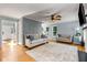 Open living room featuring hardwood floors, fireplace, and neutral-toned furniture at 4913 Farm Valley Ne Dr, Woodstock, GA 30188