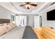 Bright main bedroom featuring tray ceilings, ensuite bathroom, and large windows at 4913 Farm Valley Ne Dr, Woodstock, GA 30188