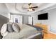 Spacious main bedroom showcasing tray ceilings, hardwood floors, and ensuite access at 4913 Farm Valley Ne Dr, Woodstock, GA 30188