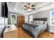 Comfortable main bedroom with tray ceilings, abundant natural light, and hardwood floors at 4913 Farm Valley Ne Dr, Woodstock, GA 30188