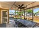 Covered porch featuring outdoor dining set and view of backyard with play set at 4913 Farm Valley Ne Dr, Woodstock, GA 30188