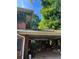 Covered brick carport offers protection and convenience with ample storage space, surrounded by lush greenery at 715 Catherine St, Forest Park, GA 30297