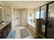 Bright bathroom featuring a shower, soaking tub, and vanity with double sinks, offering a spa-like experience at 719 Lilac Mist Dr, Loganville, GA 30052