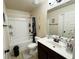 Clean bathroom with a toilet, shower, and vanity with a sink and mirror at 719 Lilac Mist Dr, Loganville, GA 30052